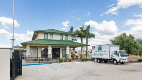 Front office building with moving truck.