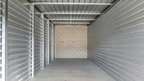 Interior of a storage unit with a concrete wall.