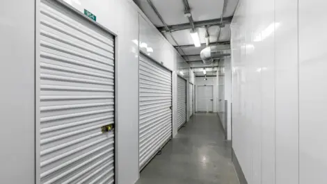 Rows of white indoor storage units.