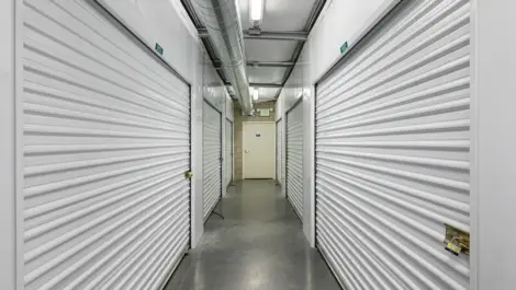 Double sided row of white indoor storage units.
