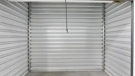 Interior of a small white walled storage unit.