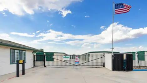 American flag above the main gate of a storage facility.