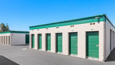 Close up of an outdoor green storage unit door.