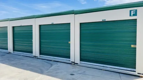 Large green outdoor storage units in a row.