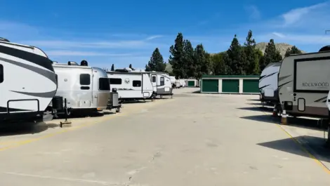 Small outdoor storage units with green doors.