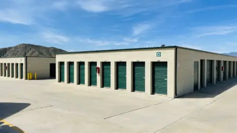 Outdoor storage units with a mountain behind them.