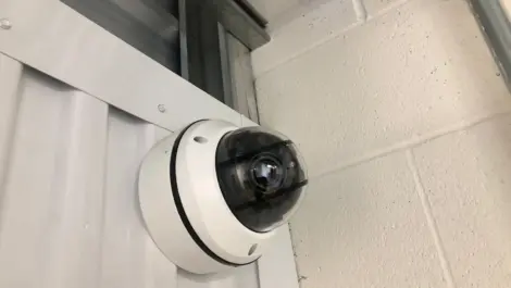 Close up of a security camera at an outdoor storage facility.